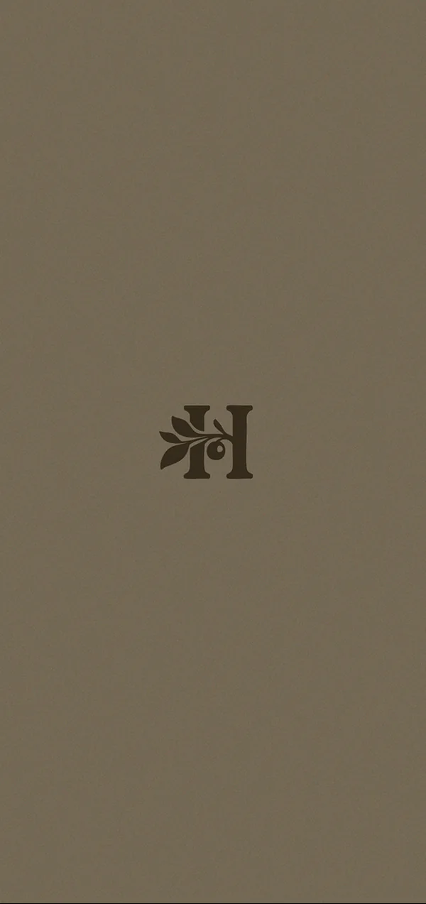 The Huckberry Farm monogram alone on bark